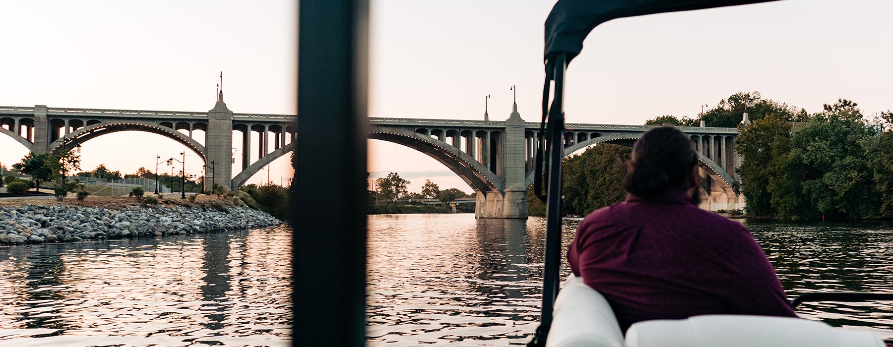 A boat sails along the Lehigh River near the Tilghman Street Bridge at The Waterfront in Allentown.
